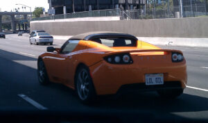 A Tesla with the license plate "LOL Oil"